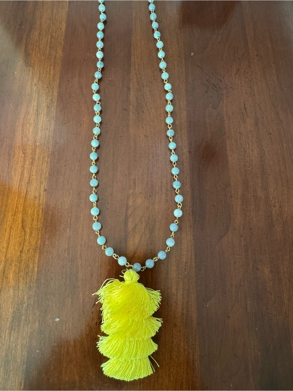 Light blue beaded necklace with yellow tassel 18.5”
